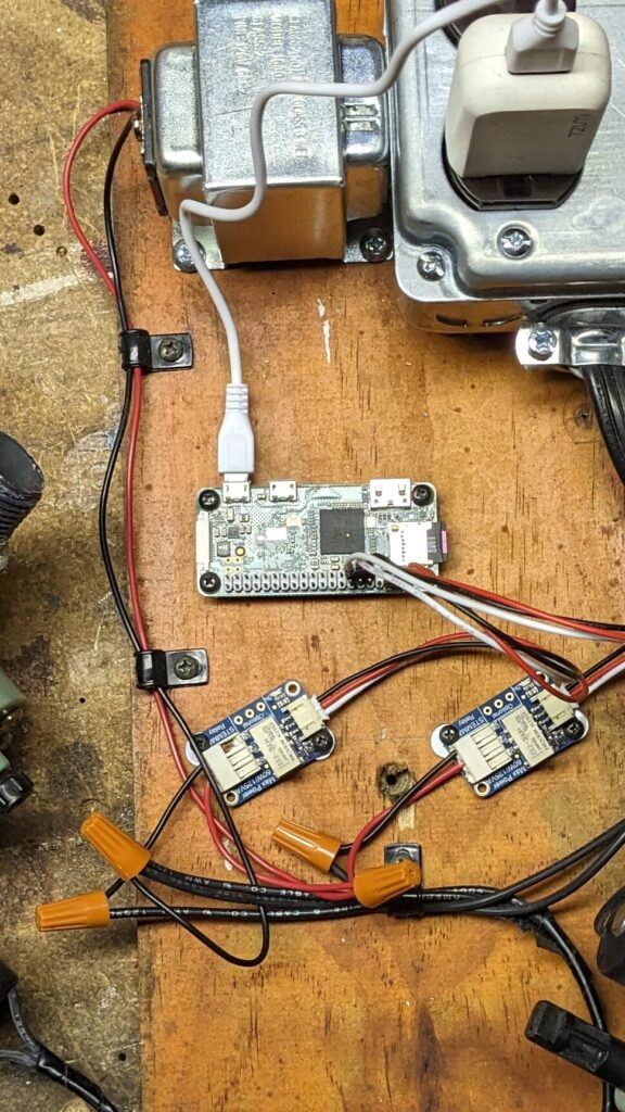 A jumble of electronics on a wood board