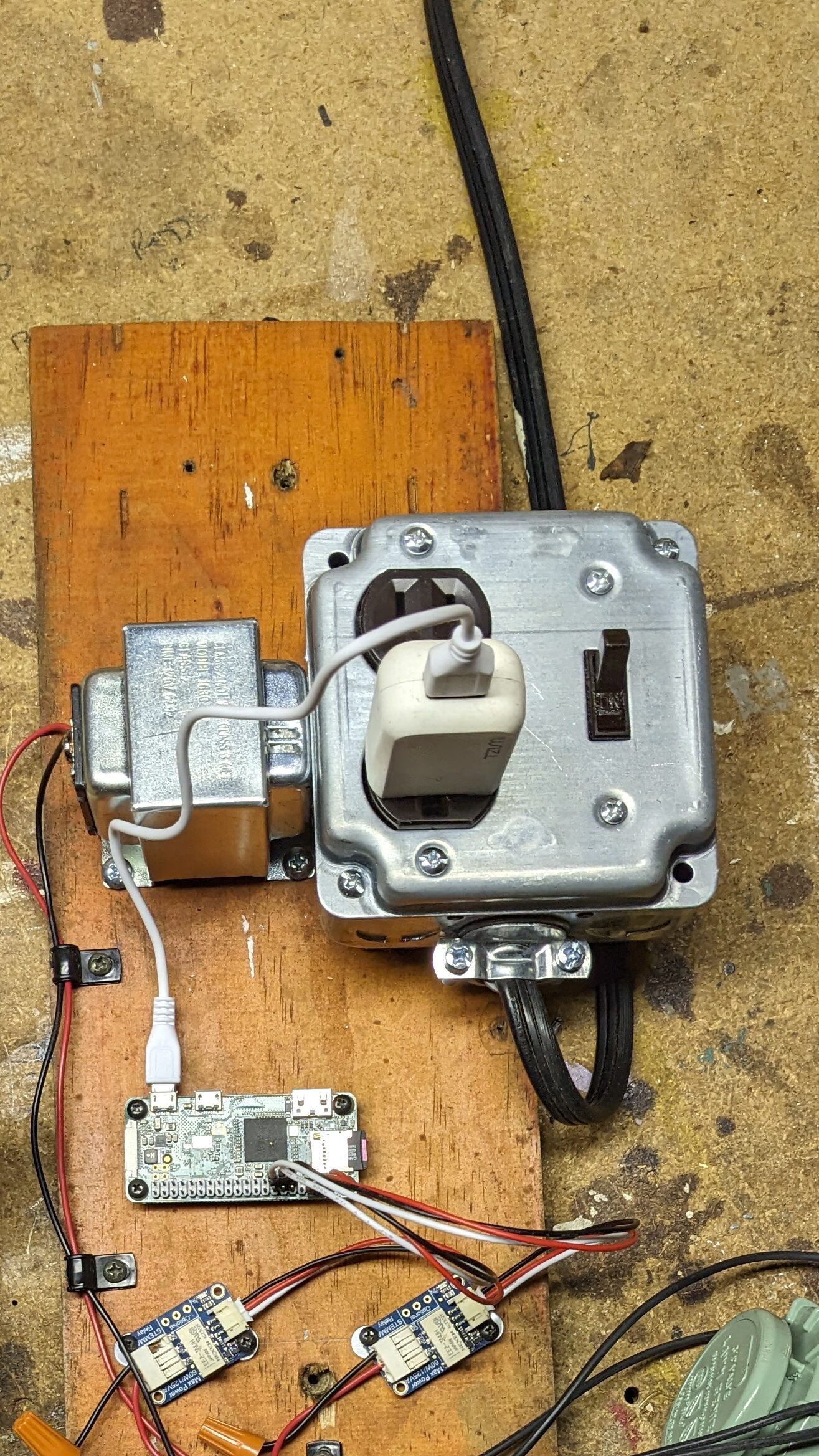 A jumble of electronics on a wood board