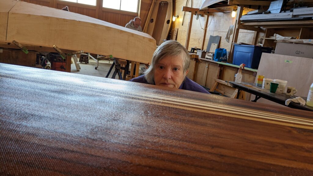 Janell is looking over the top of the cedar strip canoe