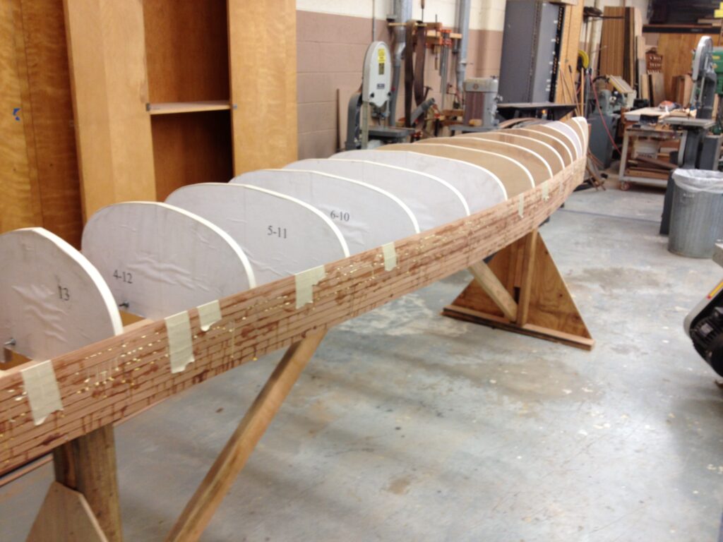 A cedar strip canoe being built on a form